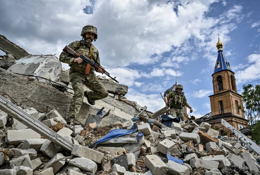 Ukrainian soldiers patrol a heavily war-damaged area of the town of Orikhiv in the Zaporizhzhia region of Ukraine on May 20.
  Ukrainian soldiers patrol a heavily war-damaged area of the town of Orikhiv in the Zaporizhzhia region of Ukraine on May 20.