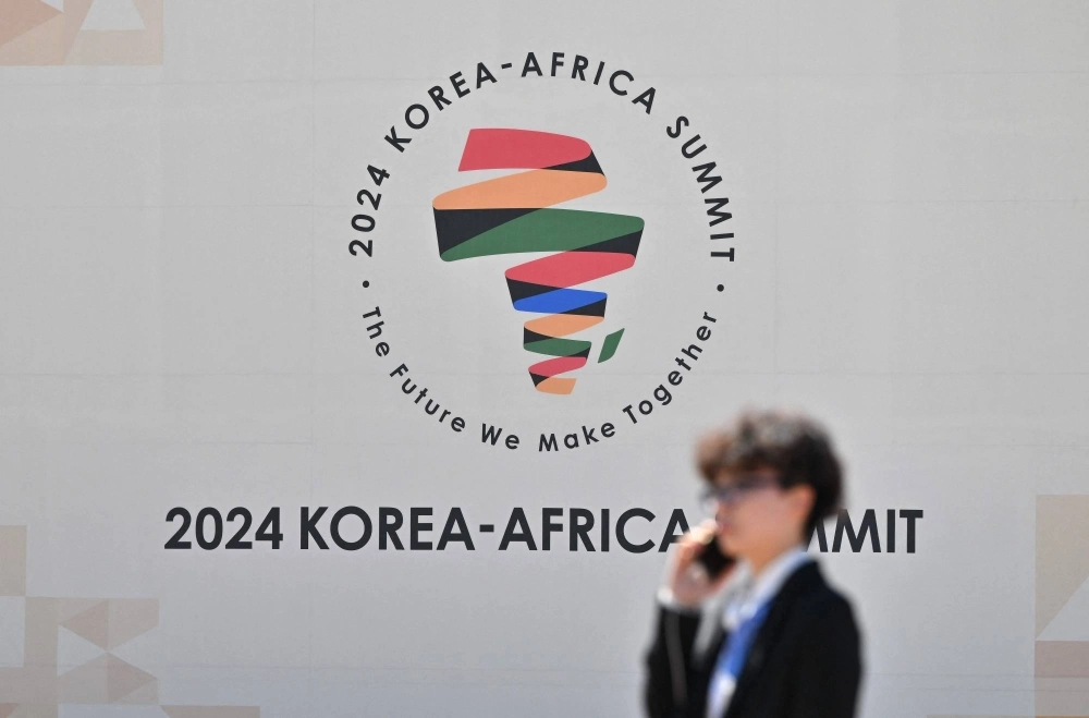 A person walks past the logo of the 2024 Korea-Africa Summit in Goyang, South Korea, on Tuesday. Seoul will aim to secure critical mineral imports and boost trade ties with Africa as President Yoon Suk-yeol hosts dozens of heads of state from the continent at a major summit. A person walks past the logo of the 2024 Korea-Africa Summit in Goyang, South Korea, on Tuesday. Seoul will aim to secure critical mineral imports and boost trade ties with Africa as President Yoon Suk-yeol hosts dozens of heads of state from the continent at a major summit.