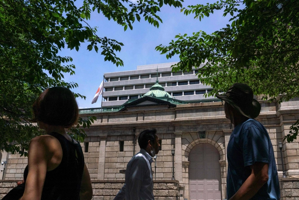 The Bank of Japan headquarters in Tokyo. More than half of the 50 economists surveyed predict the central bank will decide next week to slow the pace of bond buying. The Bank of Japan headquarters in Tokyo. More than half of the 50 economists surveyed predict the central bank will decide next week to slow the pace of bond buying.