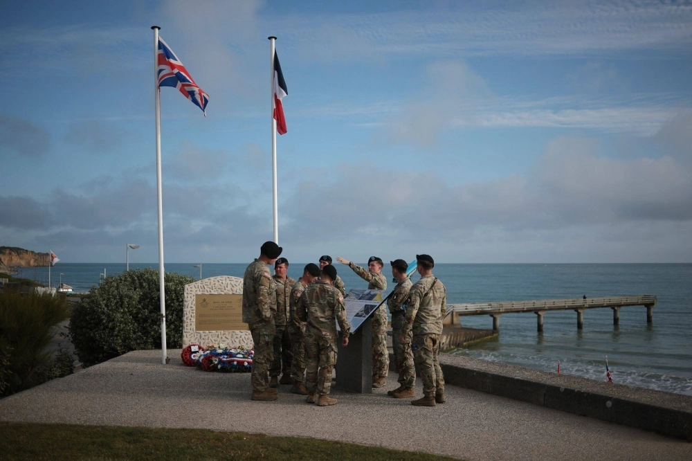 Members of the U.S. 101st Airborne Division visit a memorial on Omaha Beach in Vierville-sur-Mer on June 5. Members of the U.S. 101st Airborne Division visit a memorial on Omaha Beach in Vierville-sur-Mer on June 5.