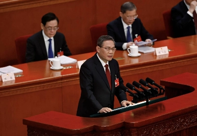 Chinese Premier Li Qiang delivers the work report at the opening session of the National People's Congress in Beijing on March 5. Li dropped the mention of "peaceful" from unification with Taiwan this year. Chinese Premier Li Qiang delivers the work report at the opening session of the National People's Congress in Beijing on March 5. Li dropped the mention of "peaceful" from unification with Taiwan this year.