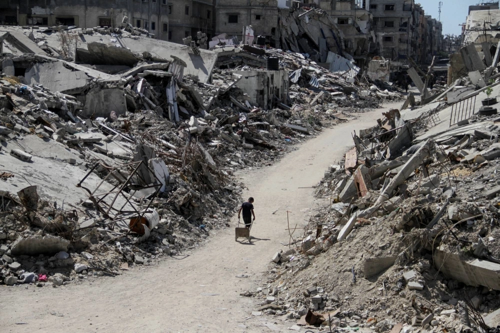 A Palestinian walks among the rubble of buildings destroyed during Israel's military offensive in Beit Lahia in the northern Gaza Strip, on Wednesday. A Palestinian walks among the rubble of buildings destroyed during Israel's military offensive in Beit Lahia in the northern Gaza Strip, on Wednesday.