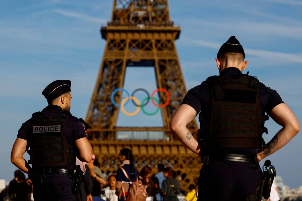 Police officers patrol on the Trocadero square in front of the Olympic rings displayed on the first floor of the Eiffel Tower ahead of the Paris 2024 Olympic games in Paris on June 7. Police officers patrol on the Trocadero square in front of the Olympic rings displayed on the first floor of the Eiffel Tower ahead of the Paris 2024 Olympic games in Paris on June 7.