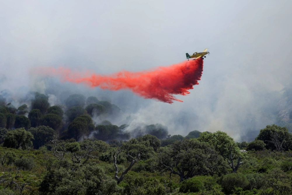 A firefighting plane disperses fire retardant over a wildfire in Puertollano, near Tarifa, Spain, on June 4. A firefighting plane disperses fire retardant over a wildfire in Puertollano, near Tarifa, Spain, on June 4.