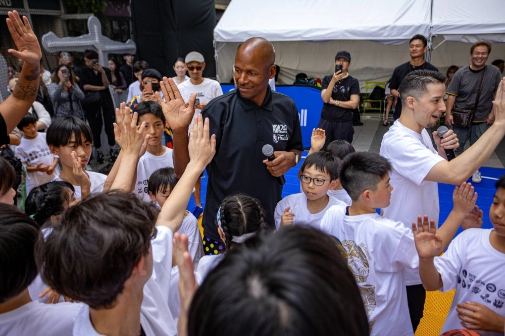 NBA legend Ray Allen high-fives children during a basketball clinic in Tokyo's Shibuya Ward on Saturday.  NBA legend Ray Allen high-fives children during a basketball clinic in Tokyo's Shibuya Ward on Saturday.