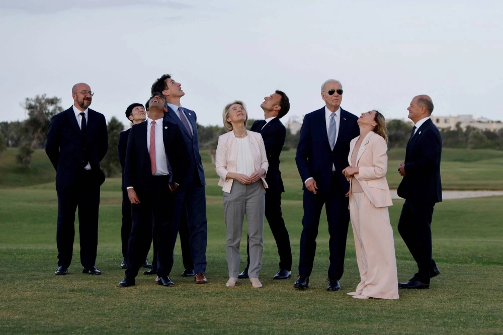 Group of Seven leaders and officials look to the sky during a ceremony involving paratroopers at Borgo Egnazia Golf Club San Domenico in Savelletri, Italy, on Thursday. Group of Seven leaders and officials look to the sky during a ceremony involving paratroopers at Borgo Egnazia Golf Club San Domenico in Savelletri, Italy, on Thursday.