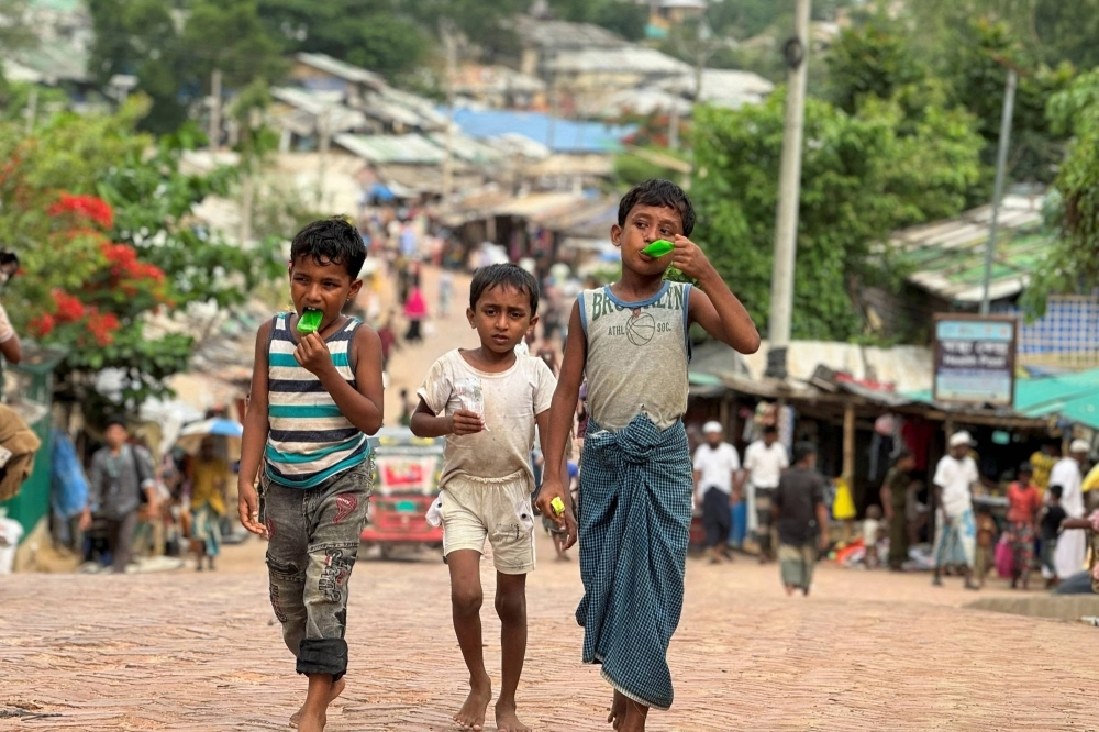 Rohingya refugee children walk along a road at a refugee camp in Cox's Bazar, Bangladesh, on May 2. Rohingya refugee children walk along a road at a refugee camp in Cox's Bazar, Bangladesh, on May 2.