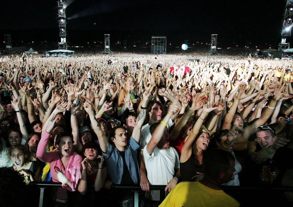 Fans cheer as the Rolling Stones perform during their concert at Magnetic Hill Park in Moncton, New Brunswick, Canada, on Sept. 3, 2005.  Fans cheer as the Rolling Stones perform during their concert at Magnetic Hill Park in Moncton, New Brunswick, Canada, on Sept. 3, 2005.