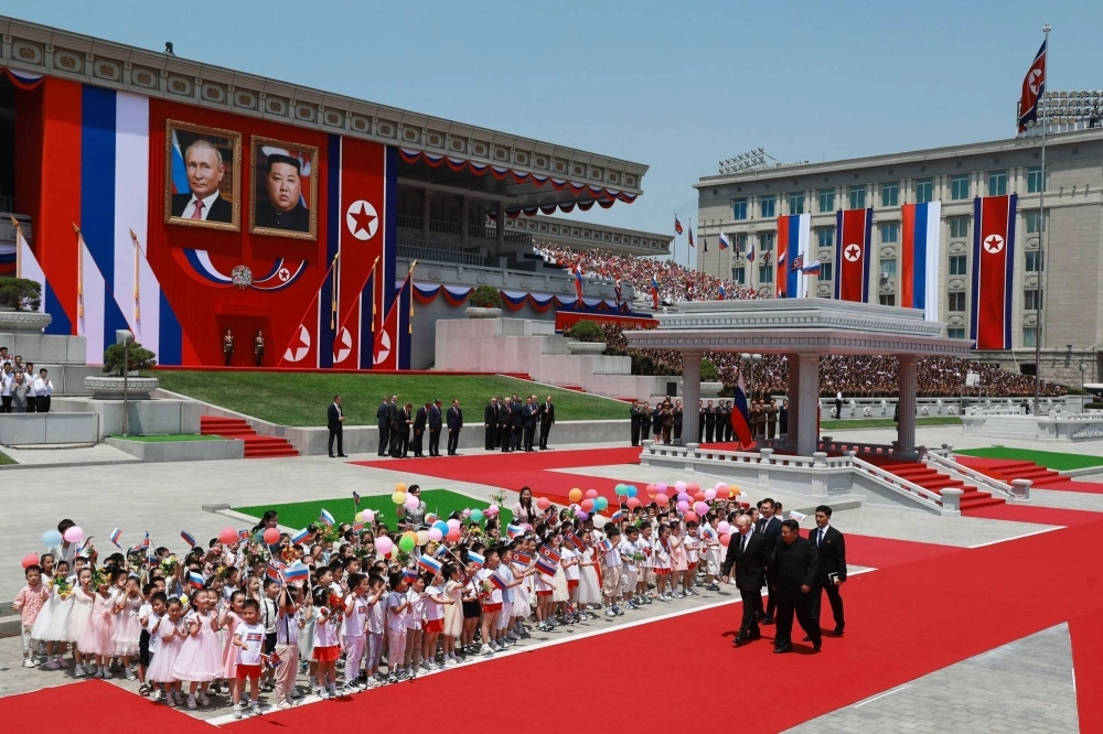 North Korean leader Kim Jong Un and Russian President Vladimir Putin walk past children during a welcoming ceremony in Pyongyang's Kim Il Sung Square on Wednesday. North Korean leader Kim Jong Un and Russian President Vladimir Putin walk past children during a welcoming ceremony in Pyongyang's Kim Il Sung Square on Wednesday.
