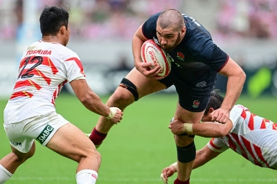 England's George Martin is tackled by Japan's Atsushi Sakate (right) and Tomoki Osada during England's win over Japan on Saturday in Tokyo.  England's George Martin is tackled by Japan's Atsushi Sakate (right) and Tomoki Osada during England's win over Japan on Saturday in Tokyo.