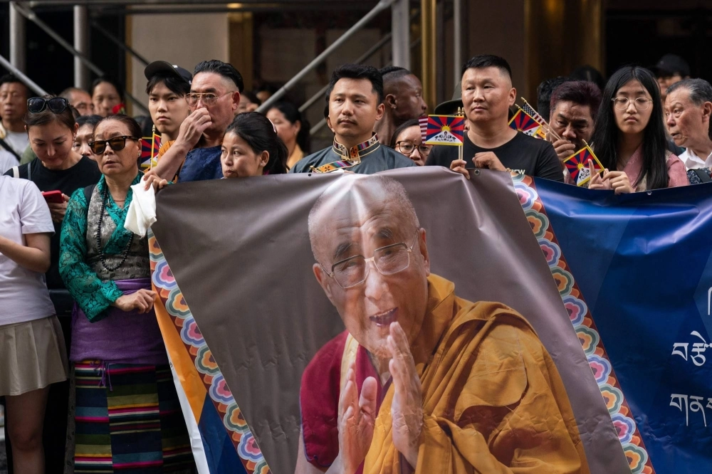 People await the arrival of the Dalai Lama in New York on Sunday. The Tibetan spiritual leader is in the U.S. to undergo knee surgery. People await the arrival of the Dalai Lama in New York on Sunday. The Tibetan spiritual leader is in the U.S. to undergo knee surgery.