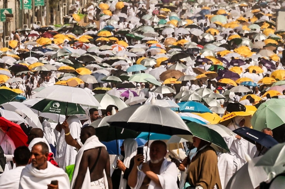 Muslim pilgrims use umbrellas to shade themselves from the sun as they arrive at the base of Mount Arafat, also known as Jabal al-Rahma or Mount of Mercy, during the annual hajj pilgrimage, on June 15. Muslim pilgrims use umbrellas to shade themselves from the sun as they arrive at the base of Mount Arafat, also known as Jabal al-Rahma or Mount of Mercy, during the annual hajj pilgrimage, on June 15.