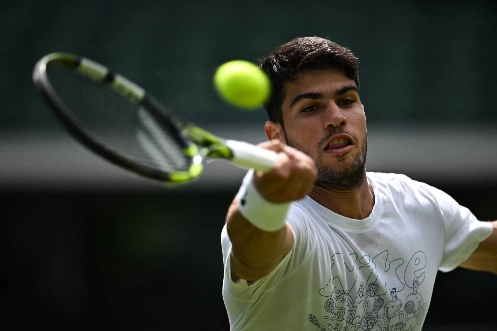Carlos Alcaraz takes part in a practice session at the All England Lawn Tennis Club in London on Thursday ahead of the start of Wimbledon.  Carlos Alcaraz takes part in a practice session at the All England Lawn Tennis Club in London on Thursday ahead of the start of Wimbledon.