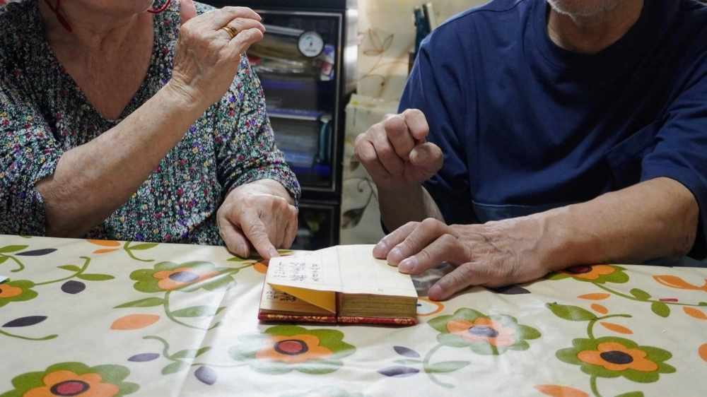 Hanako and Taro Nomura, who are suing the government over forced sterilization, show their late daughter's birth register issued by a temple, in their living room in a city in Osaka Prefecture. For years, the couple wondered why they could not conceive after the death of their firstborn. Hanako and Taro Nomura, who are suing the government over forced sterilization, show their late daughter's birth register issued by a temple, in their living room in a city in Osaka Prefecture. For years, the couple wondered why they could not conceive after the death of their firstborn.