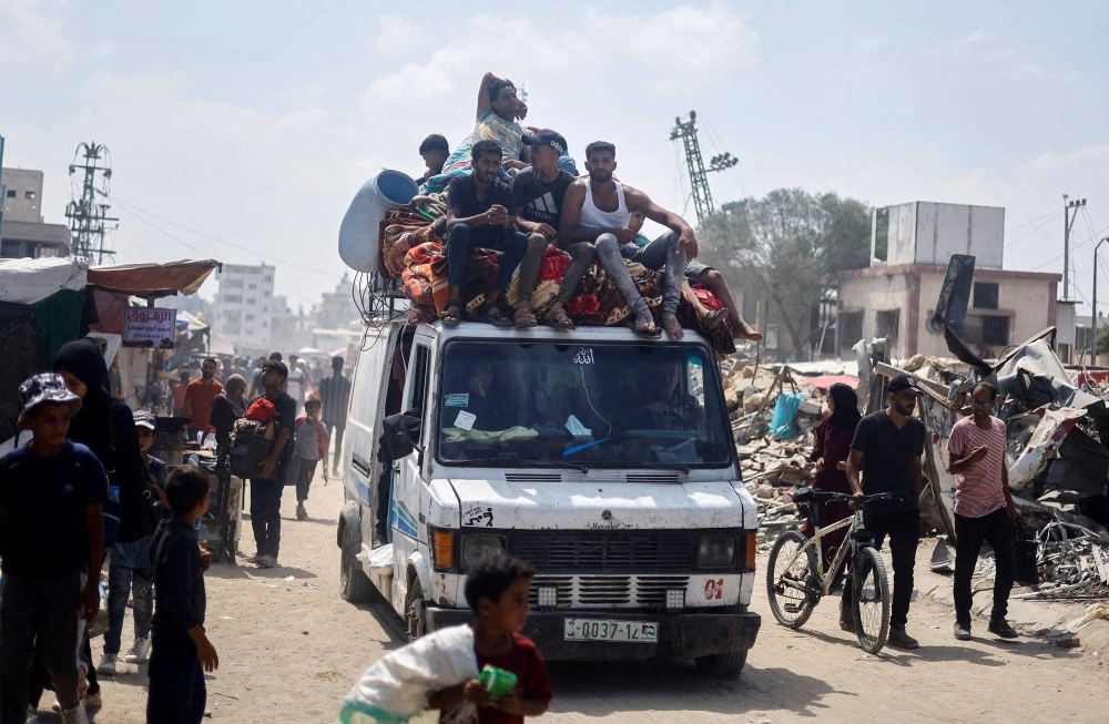 Palestinians, who fled the eastern part of Khan Younis after they were ordered by the Israeli army to evacuate their neighborhoods, ride on a vehicle loaded with belongings in the southern Gaza Strip on Tuesday. Palestinians, who fled the eastern part of Khan Younis after they were ordered by the Israeli army to evacuate their neighborhoods, ride on a vehicle loaded with belongings in the southern Gaza Strip on Tuesday.