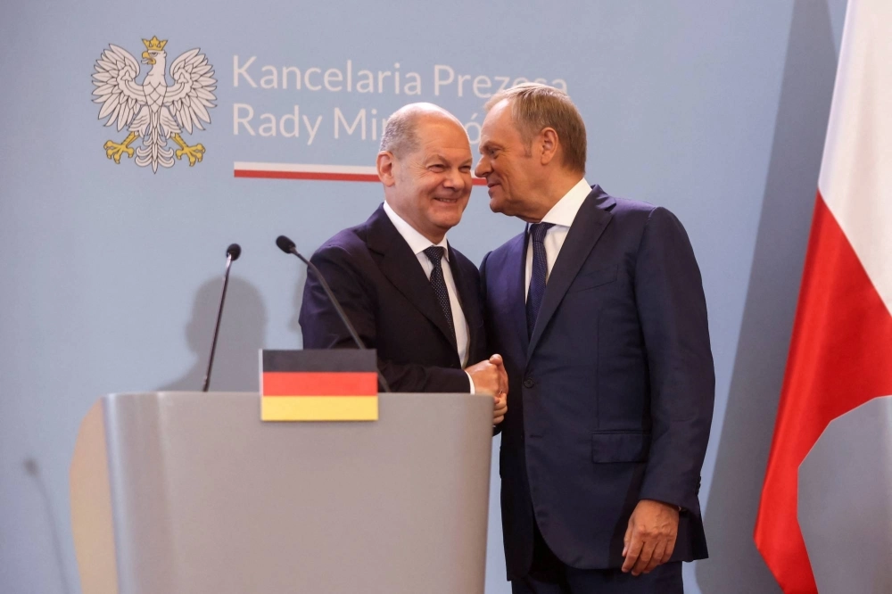 German Chancellor Olaf Scholz (left) and Polish Prime Minister Donald Tusk shake hands as they attend a press conference in Warsaw on Tuesday. German Chancellor Olaf Scholz (left) and Polish Prime Minister Donald Tusk shake hands as they attend a press conference in Warsaw on Tuesday.