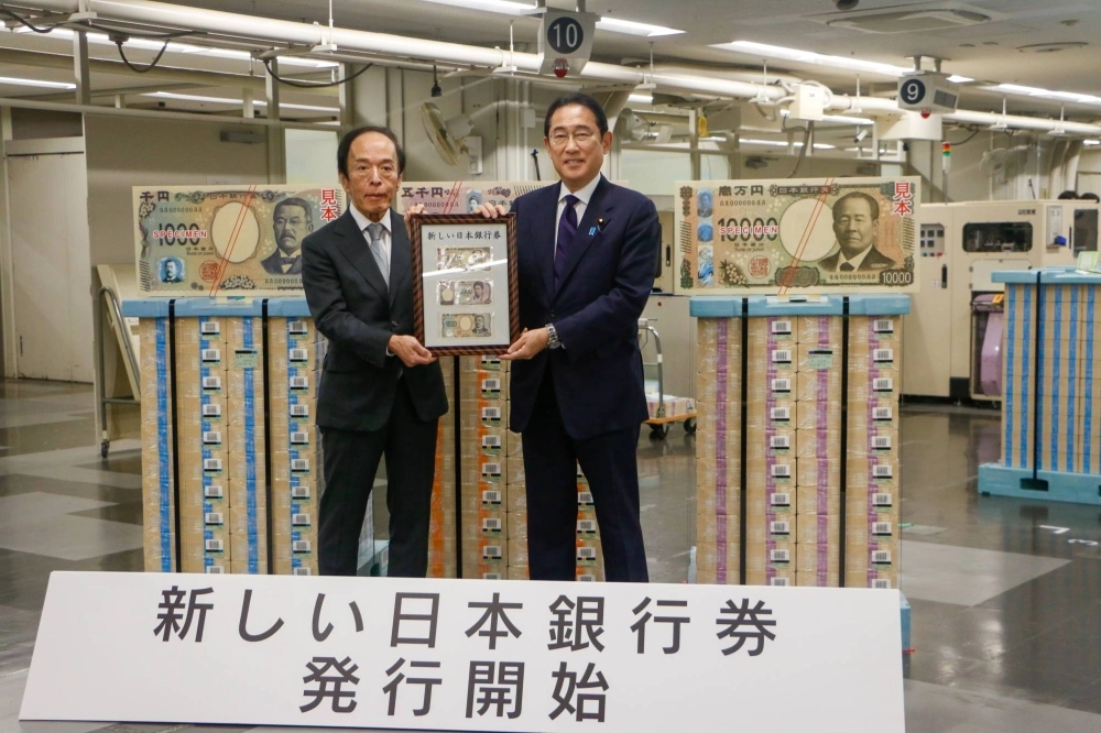 Bank of Japan Gov. Kazuo Ueda and Prime Minister Fumio Kishida show off the new banknotes in Tokyo on Wednesday. Bank of Japan Gov. Kazuo Ueda and Prime Minister Fumio Kishida show off the new banknotes in Tokyo on Wednesday.