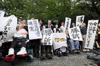 Plaintiffs of a series of lawsuits on forced sterilization and their lawyers hold banners saying "victory ruling" after the Supreme Court ruled in their favor in Tokyo on Wednesday. Plaintiffs of a series of lawsuits on forced sterilization and their lawyers hold banners saying "victory ruling" after the Supreme Court ruled in their favor in Tokyo on Wednesday.