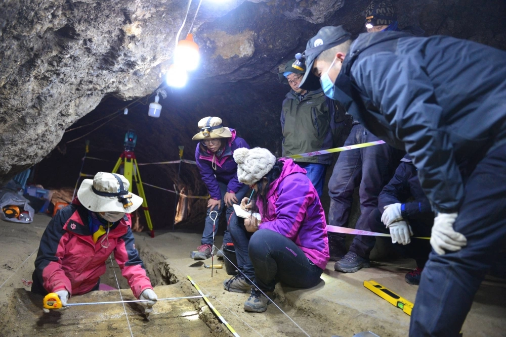 Scientists work inside Baishiya Karst Cave, where the remains of the extinct archaic human species called Denisovans — as well as bones of blue sheep and various other animals — have been discovered, on the northeastern edge of the Tibetan Plateau in China's Gansu province, in this undated handout photograph. Scientists work inside Baishiya Karst Cave, where the remains of the extinct archaic human species called Denisovans — as well as bones of blue sheep and various other animals — have been discovered, on the northeastern edge of the Tibetan Plateau in China's Gansu province, in this undated handout photograph.