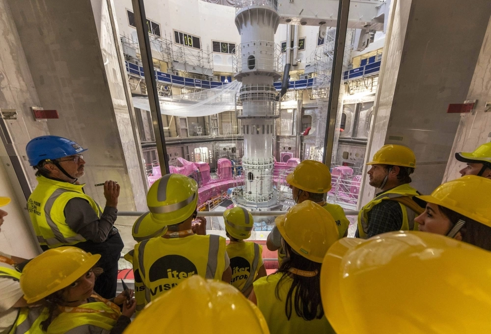 Members of the public look at the under-construction tokamak reactor at the ITER project in southern France on April 13. Members of the public look at the under-construction tokamak reactor at the ITER project in southern France on April 13.
