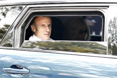 French President Emmanuel Macron and French First Lady Brigitte Macron leave after voting in the second round of French parliamentary elections at a polling station in Le Touquet-Paris-Plage, France, on Sunday. French President Emmanuel Macron and French First Lady Brigitte Macron leave after voting in the second round of French parliamentary elections at a polling station in Le Touquet-Paris-Plage, France, on Sunday.