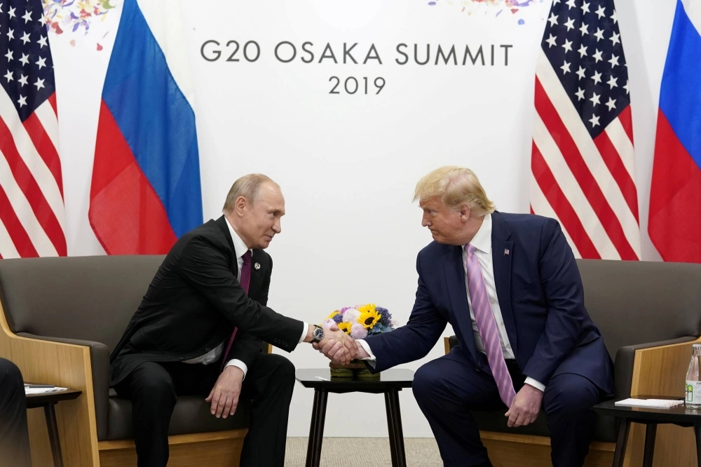 Russian President Vladimir Putin and U.S. President Donald Trump shake hands during a bilateral meeting at the Group of 20 leaders summit in Osaka in June 2019. Russian President Vladimir Putin and U.S. President Donald Trump shake hands during a bilateral meeting at the Group of 20 leaders summit in Osaka in June 2019.