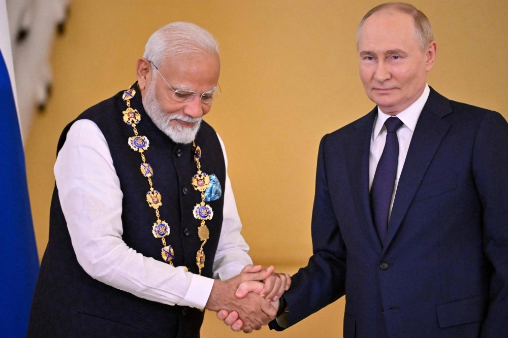 Russian President Vladimir Putin decorates Indian Prime Minister Narendra Modi with the Order of St. Andrew the Apostle the First-Called during a ceremony following their talks at the Kremlin in Moscow on Tuesday. Russian President Vladimir Putin decorates Indian Prime Minister Narendra Modi with the Order of St. Andrew the Apostle the First-Called during a ceremony following their talks at the Kremlin in Moscow on Tuesday.