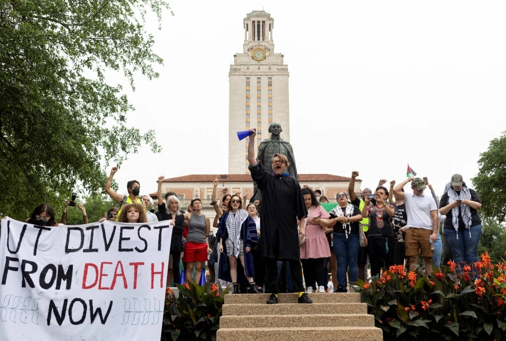 University of Texas at Austin Anthropology Professor Craig Campbell leads chants with other university faculty members during a pro-Palestinian protest on the campus in Austin, Texas, on May 5. University of Texas at Austin Anthropology Professor Craig Campbell leads chants with other university faculty members during a pro-Palestinian protest on the campus in Austin, Texas, on May 5.