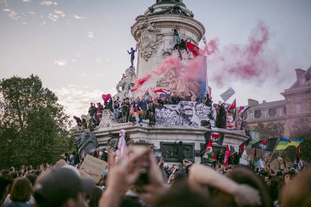 People celebrate after the second round of the French legislative elections at Place de la Republic in Paris on Sunday. Three distinct left-wing, right-wing and centrist blocs emerged from the vote. People celebrate after the second round of the French legislative elections at Place de la Republic in Paris on Sunday. Three distinct left-wing, right-wing and centrist blocs emerged from the vote.