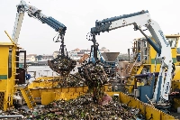 Heavy machinery collects waste from the Chao Phraya river in Bangkok. | Bloomberg