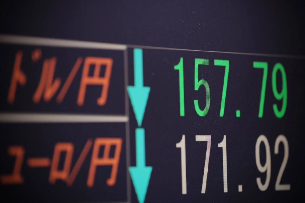 A monitor in Tokyo shows the yen strengthening to the ¥157 range against the dollar late Thursday evening. A monitor in Tokyo shows the yen strengthening to the ¥157 range against the dollar late Thursday evening.