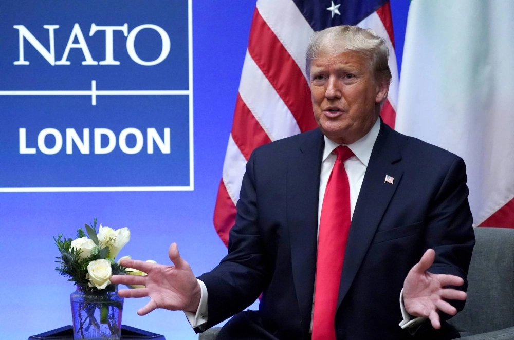 Then-U.S. President Donald Trump gestures during a meeting on the sidelines of the NATO summit in Watford, England, in December 2019. Then-U.S. President Donald Trump gestures during a meeting on the sidelines of the NATO summit in Watford, England, in December 2019.