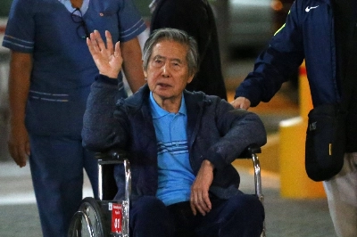 Peru's former President Alberto Fujimori waves to supporters as he is wheeled out of the Centenario Clinic in Lima on Jan. 04, 2018. He was sent to prison in 2009 over massacres committed by army death squads in the 1990s but was released last year for humanitarian reasons.  Peru's former President Alberto Fujimori waves to supporters as he is wheeled out of the Centenario Clinic in Lima on Jan. 04, 2018. He was sent to prison in 2009 over massacres committed by army death squads in the 1990s but was released last year for humanitarian reasons.