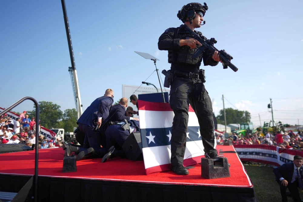 Secret Service agents cover former President Donald Trump immediately after an assassination attempt at a campaign rally in Butler, Pennsylvania, on Saturday. The incident highlights America's historical and ongoing political violence.
  Secret Service agents cover former President Donald Trump immediately after an assassination attempt at a campaign rally in Butler, Pennsylvania, on Saturday. The incident highlights America's historical and ongoing political violence.