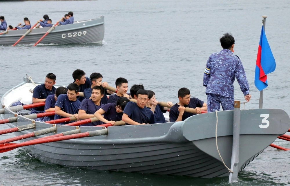 Cadets at the Maritime Self-Defense Force’s Kure Recruit Training Center row in unison during a cutter boat drill in Kure Bay, Hiroshima Prefecture, in June. Cadets at the Maritime Self-Defense Force’s Kure Recruit Training Center row in unison during a cutter boat drill in Kure Bay, Hiroshima Prefecture, in June.