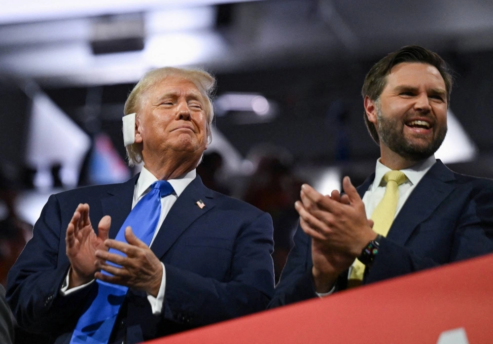 Republican presidential nominee and former U.S. President Donald Trump and Republican vice presidential nominee JD Vance applaud on the second day of the Republican National Convention, at the Fiserv Forum in Milwaukee, Wisconsin, on Tuesday. Republican presidential nominee and former U.S. President Donald Trump and Republican vice presidential nominee JD Vance applaud on the second day of the Republican National Convention, at the Fiserv Forum in Milwaukee, Wisconsin, on Tuesday.