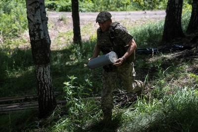 A Ukrainian serviceman prepares a shell for a self-propelled howitzer at a position on a front line in Kharkiv, Ukraine, in June. A Ukrainian serviceman prepares a shell for a self-propelled howitzer at a position on a front line in Kharkiv, Ukraine, in June.