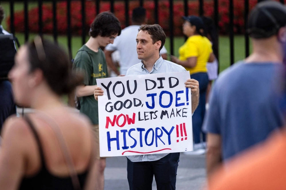 A demonstrator shows appreciation for U.S. President Joe Biden near the White House after Biden announced his exit from the election and endorsement of Vice President Kamala Harris. A demonstrator shows appreciation for U.S. President Joe Biden near the White House after Biden announced his exit from the election and endorsement of Vice President Kamala Harris.