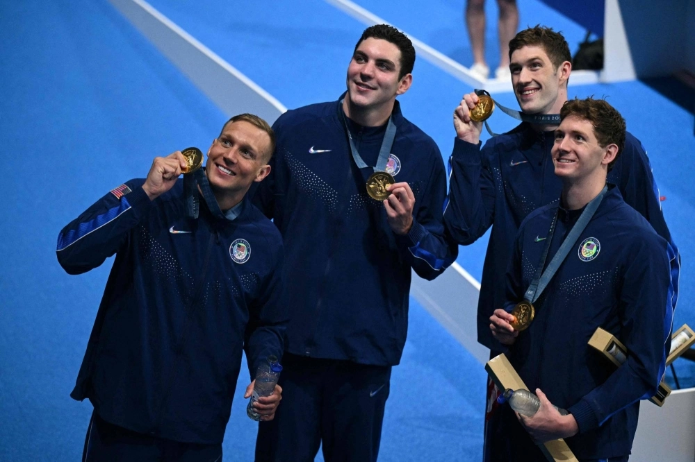 American gold medalists Jack Alexy, Chris Guiliano, Hunter Armstrong and Caeleb Dressel celebrate after winning the 4x100-meter freestyle relay on Saturday at the Paris Olympics.  American gold medalists Jack Alexy, Chris Guiliano, Hunter Armstrong and Caeleb Dressel celebrate after winning the 4x100-meter freestyle relay on Saturday at the Paris Olympics.