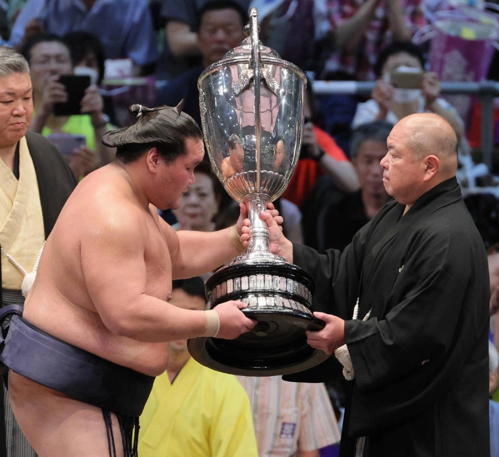 Terunofuji accepts the Emperor's Cup after winning the Nagoya Grand Sumo Tournament on Sunday.  Terunofuji accepts the Emperor's Cup after winning the Nagoya Grand Sumo Tournament on Sunday.
