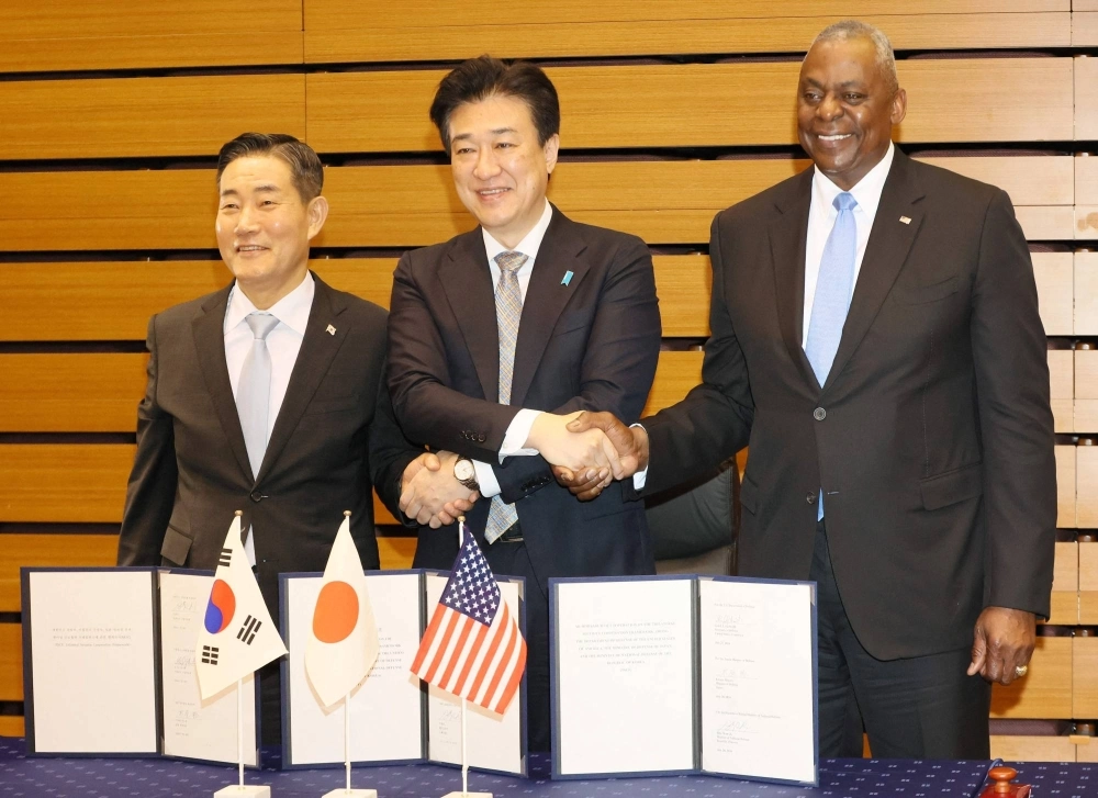 South Korean Defense Minister Shin Won-sik (left to right), Defense Minister Minoru Kihara and U.S. Defense Secretary Lloyd Austin pose for a photo at the Defense Ministry Sunday. South Korean Defense Minister Shin Won-sik (left to right), Defense Minister Minoru Kihara and U.S. Defense Secretary Lloyd Austin pose for a photo at the Defense Ministry Sunday.