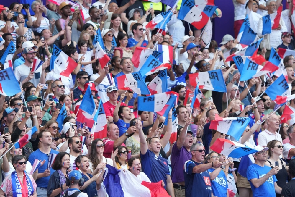 French fans cheer on their team during an Olympic rugby sevens match on Sunday. Fans are back in force at the Games and providing a lively atmosphere for the competition after COVID-19 forced the Tokyo and Beijing Olympics to be mostly played without spectators. French fans cheer on their team during an Olympic rugby sevens match on Sunday. Fans are back in force at the Games and providing a lively atmosphere for the competition after COVID-19 forced the Tokyo and Beijing Olympics to be mostly played without spectators.