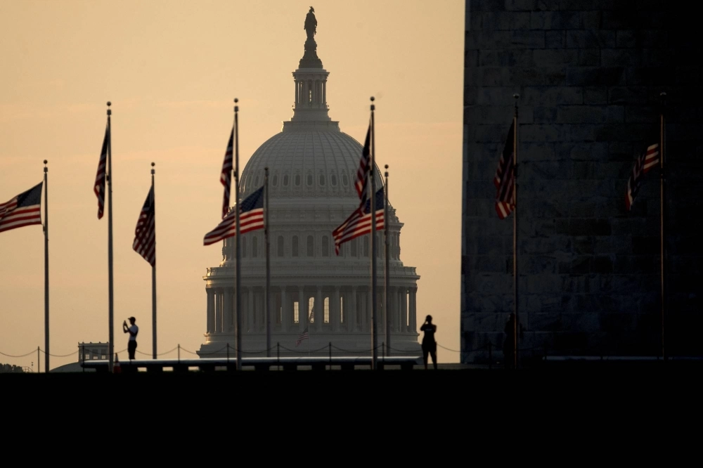 The U.S. Capitol building stands past visitors taking photographs at the Washington Monument in Washington in 2017. The U.S. Capitol building stands past visitors taking photographs at the Washington Monument in Washington in 2017.