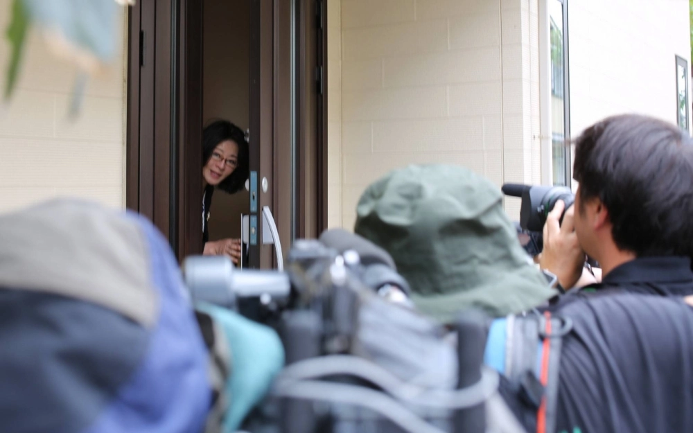 Upper House lawmaker Megumi Hirose enters her house in Tokyo after it was raided on Tuesday. Upper House lawmaker Megumi Hirose enters her house in Tokyo after it was raided on Tuesday.