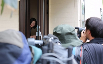 Upper House lawmaker Megumi Hirose enters her house in Tokyo after it was raided on Tuesday. Upper House lawmaker Megumi Hirose enters her house in Tokyo after it was raided on Tuesday.