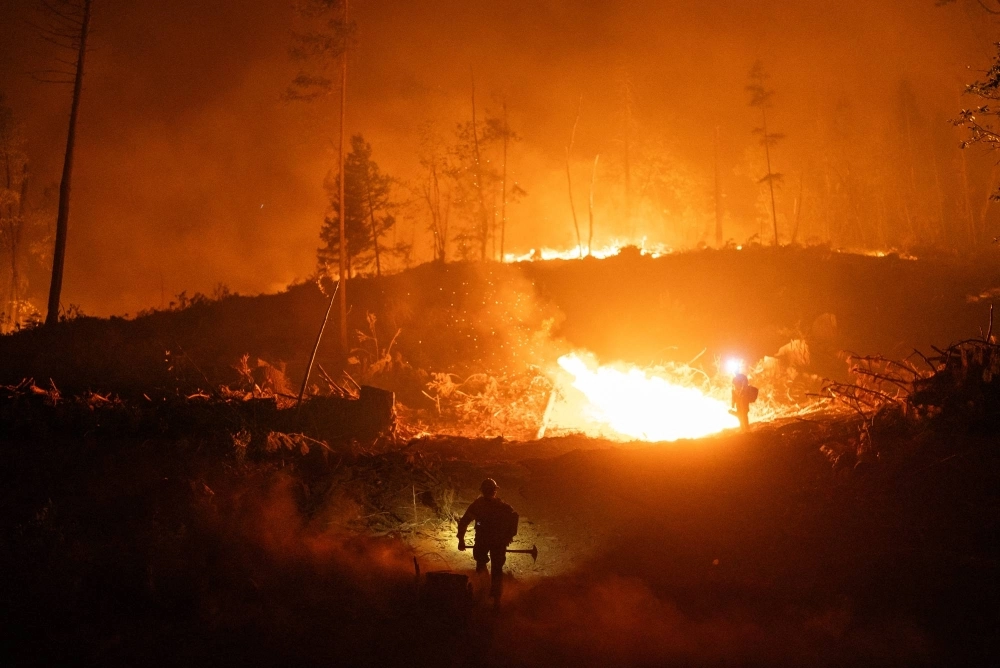 Firefighters monitor a controlled burn near Chico, California, on Tuesday. Firefighters monitor a controlled burn near Chico, California, on Tuesday.