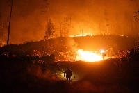 Firefighters monitor a controlled burn near Chico, California, on Tuesday. | Loren Elliott / The New York Times