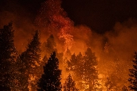 Embers rise into the air as firefighters set a controlled burn along Highway 32 near Chico, California, on Tuesday.  | Loren Elliott / The New York Times
