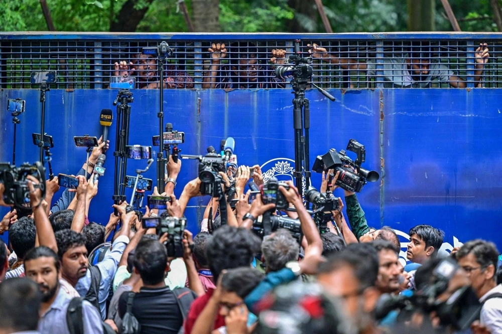 Protesters are being detained in a police van while protesting outside the High Court building as they demand justice for the victims arrested and killed in the recent countrywide violence in Dhaka on Tuesday. Protesters are being detained in a police van while protesting outside the High Court building as they demand justice for the victims arrested and killed in the recent countrywide violence in Dhaka on Tuesday.