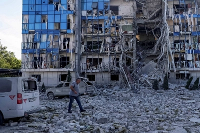 A man walks next to an office building of FSD (Fondation Suisse de Déminage), a nongovernmental humanitarian organization, damaged during a Russian missile attack in Kharkiv, Ukraine, on July 24. A man walks next to an office building of FSD (Fondation Suisse de Déminage), a nongovernmental humanitarian organization, damaged during a Russian missile attack in Kharkiv, Ukraine, on July 24.